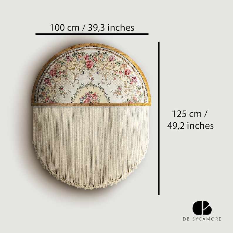 May include: A half-circle wall hanging with a floral tapestry design and a fringe of white yarn. The tapestry is framed in wood and has a diameter of 100 cm. The fringe is 125 cm long.