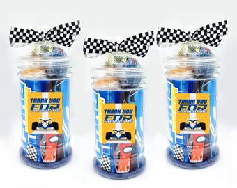 May include: Three clear glass jars with lids decorated with black and white checkered ribbon bows. Each jar contains candy and a small printed tag that says "Thank you for joining me". The tag features a cartoon race car.