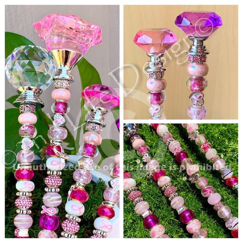 May include: Four pink and purple crystal topped garden stakes with pink and white beads, pink ribbon accents, and a pink ribbon charm with the word "HOPE" on it.
