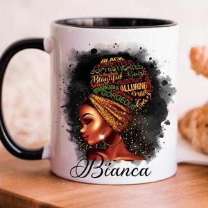 May include: White ceramic mug with a black handle and rim. The mug features a graphic of a woman with a head wrap, with words like "Black", "Gorgeous", and "Beautiful". The name "Bianca" is written on the mug.