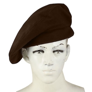 May include: A brown beret hat on a mannequin head.