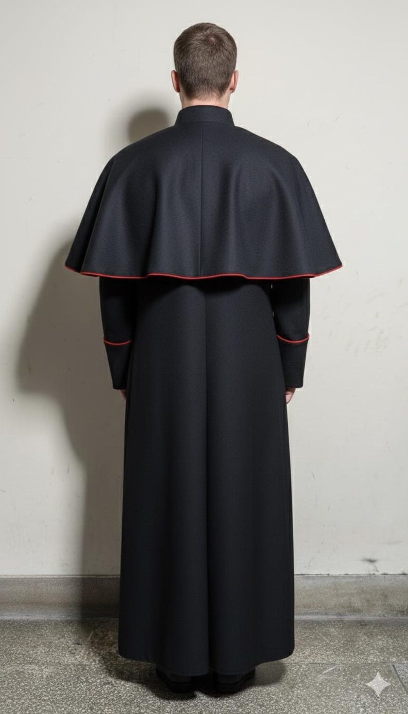May include: A long, black clerical robe with a matching cape. The cape and cuffs are trimmed with a thin red border. The garment is worn by a person facing away from the camera.