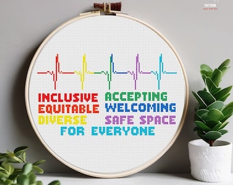 May include: Cross stitch pattern with a rainbow colored heartbeat and the words "Inclusive, Equitable, Diverse, Accepting, Welcoming, Safe Space, For Everyone".