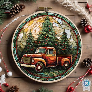 May include: A cross stitch pattern of a red vintage pickup truck with a Christmas tree in the bed, driving through a forest of pine trees with a stained glass effect.