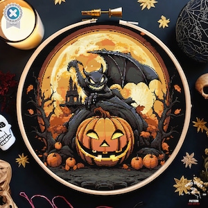 May include: A cross stitch pattern featuring a black bat with red eyes perched on a jack-o'-lantern with a full moon in the background.