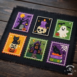 May include: A black fabric piece featuring six rectangular cross-stitch designs with Halloween themes, including a graveyard, a skull with a candle, a ghost, a cat on pumpkins, a haunted house, and a raven on books, with a frayed edge finish.