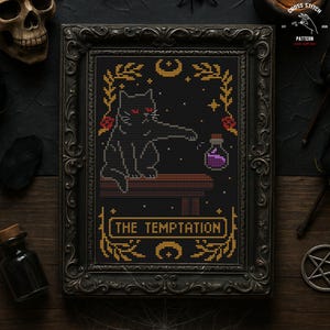 May include: Cross-stitch pattern in a black ornate frame. The design features a black cat with red eyes, reaching for a purple potion bottle. The text "THE TEMPTATION" is displayed in gold. The overall theme is gothic and witchy.