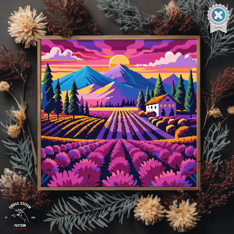May include: A cross stitch pattern featuring a colorful landscape with a house, mountains, and a field of lavender flowers. The sky is a vibrant pink and orange with a bright yellow sun.