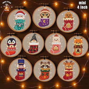 May include: Eleven mini 10 cm cross-stitch patterns in wooden hoops. Each features a different Christmas character, including Santa, an owl, a gingerbread man, a penguin, a gnome, a lamb, a fox, a nutcracker, a raccoon, and a deer, all in stockings.