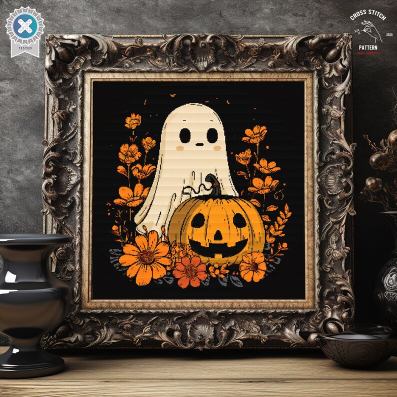 May include: Cross-stitch pattern featuring a ghost, pumpkin, and orange flowers on black, framed in a dark ornate frame. The words "CROSS STITCH PATTERN" and the year "2020" are in the upper right corner. A Halloween-themed design.