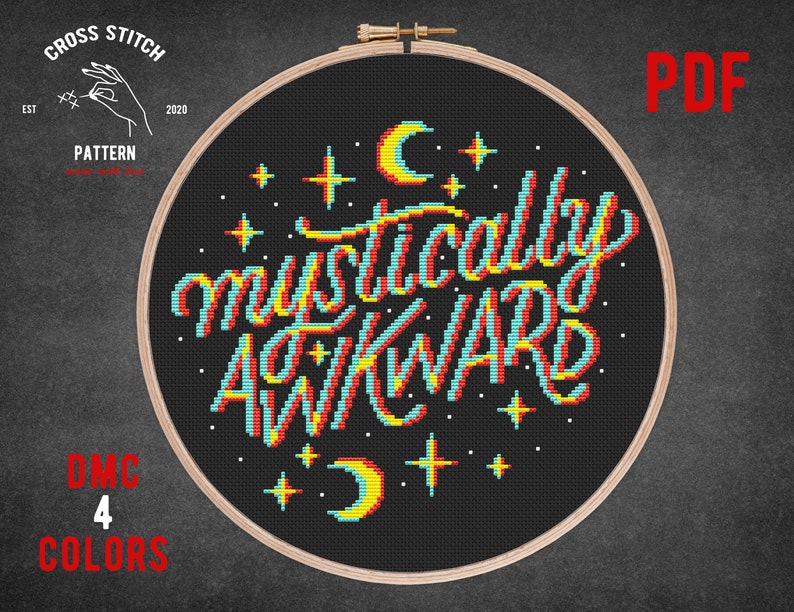May include: Cross stitch pattern for a hoop with a black background and the text "Musically Awkward" in a retro font with yellow, red, blue, and white accents. The text is surrounded by stars and crescent moons.