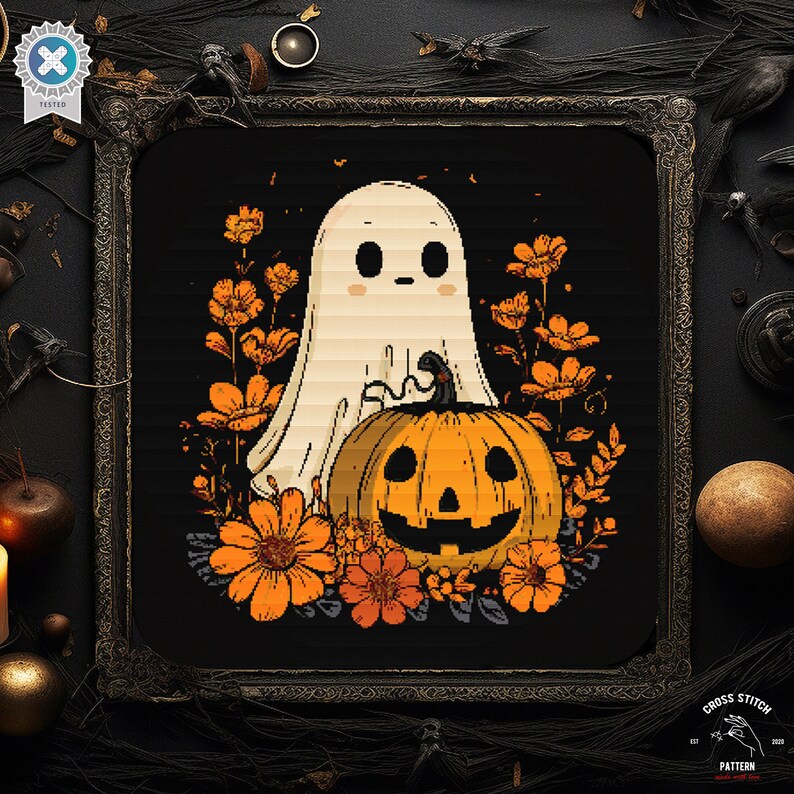 May include: A Halloween cross-stitch design showing a ghost and a carved pumpkin with orange flowers, set against a black background within a decorative frame. The words "Cross Stitch Pattern" are at the bottom of the image.