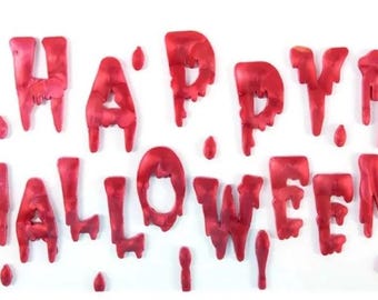 May include: Red dripping letters spelling out "Happy Halloween" on a white background.