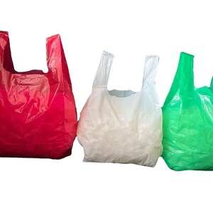 May include: Three plastic shopping bags, one red, one white, and one green, are arranged in a row against a white background.