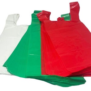 May include: A stack of plastic bags in white, green, and red. The bags are folded and stacked on top of each other.