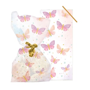 May include: A cellophane bag tied with a gold ribbon, filled with baked goods. The bag and matching card feature a watercolour butterfly pattern in pink, purple, and peach. Small gold dots and hearts complete the design.