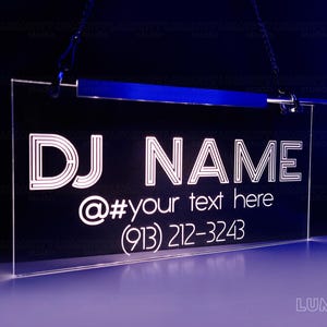 May include: A white neon sign with the text "DJ NAME @#your text here (913) 212-3243" on a black background.