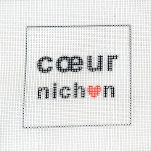 May include: A white square canvas with the words "cœur nichon" in black block letters, with a red heart replacing the "o" in "nichon". The canvas is surrounded by a black border.