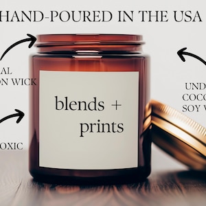 May include: A brown glass candle jar with a white label that reads "blends + prints". The candle is hand-poured in the USA and made with undyed coconut soy wax. It has a natural cotton wick and is non-toxic.
