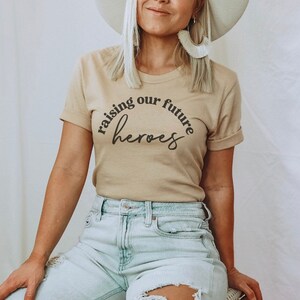 Raising the Future Shirt | Mama Tee | Mama Shirt | Trendy Shirt for Her | Mom Shirt | Raising Future Heros T-Shirt | Custom Shirt for Mom |