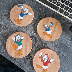 Themed hand painted wood coasters, handpainted coasters, handpainted themed coasters. Favourite character coasters