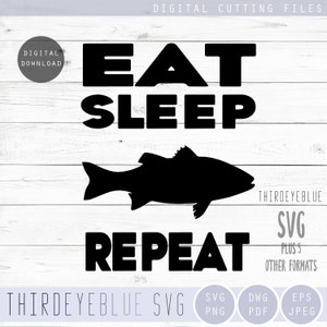 May include: Black and white graphic design with the text "Eat Sleep Repeat" and a silhouette of a fish. The design is on a white wood background.