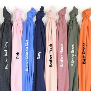 a bunch of different colored ties hanging on a wall