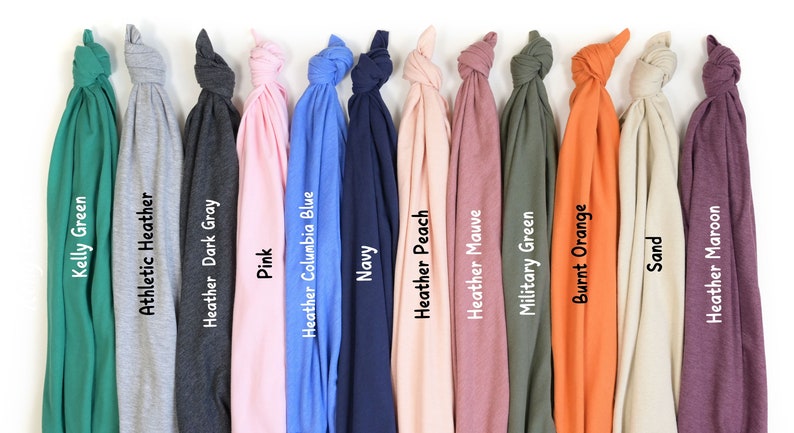 a bunch of different colored ties hanging on a wall