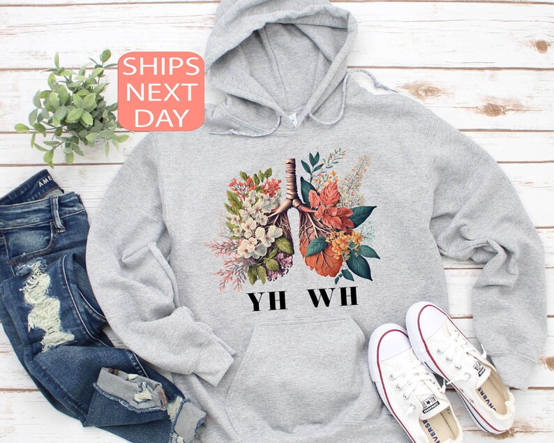 May include: Gray hoodie with a floral illustration of lungs and the text "YHW WH" printed on the front.