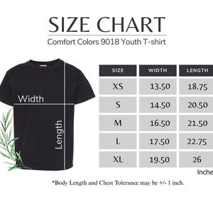 The image is a size chart for a youth t-shirt, providing measurements for different body sizes. The chart includes a black t-shirt and a plant, with the t-shirt labeled as a "Comfort Colors 9018 Youth T-shirt". The chart provides measurements for width, length, and chest size, with the width ranging from 13.50 to 18.75 inches, the length from 14.50 to 20.50 inches, and the chest size from 16.50 to 21.50 inches. The chart also mentions that "Body Length and Chest Tolerance may be +1 inch".