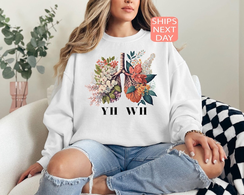 May include: White sweatshirt with a floral design of lungs and the text "YH WH" printed on the front.