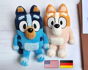May include: Two crocheted stuffed dog toys. One is blue with brown ears and a black nose. The other is orange with white ears and a black nose.