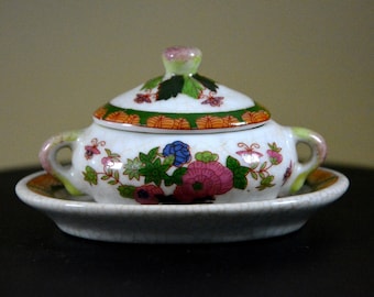 signed Porcelain Art Antique porcelain France with saucer and cover. hand decorated adorable miniature
