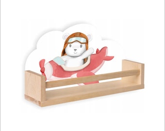 May include: A wooden shelf with a white cloud-shaped panel featuring a cartoon polar bear wearing a pilot's hat and goggles, flying a red airplane.