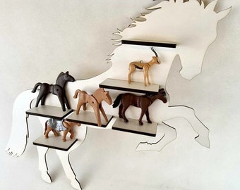 May include: White wooden horse silhouette wall shelf with five shelves. The shelves are filled with various toy animals, including horses, a gazelle, and a knight on horseback.