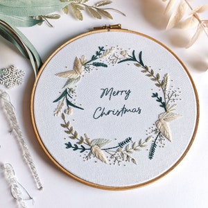 Merry Christmas Wreath Hand Embroidery Pattern Digital Download PDF by Tales from the Hoop. A beautiful festive design with winter florals berries and flowers in understated soft modern colours with metallic gold accents. Christmas handmade wall art.