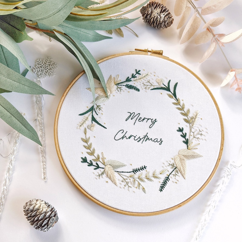 Merry Christmas Wreath Hand Embroidery Pattern Digital Download PDF by Tales from the Hoop. A beautiful festive design with winter florals berries and flowers in understated soft modern colours with metallic gold accents. Christmas handmade wall art.