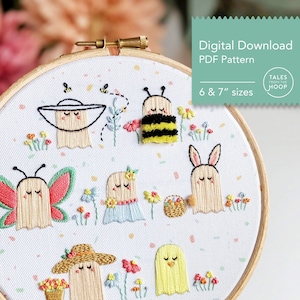May include: Embroidered hoop art featuring a whimsical scene of ghosts dressed in various costumes, including a bee, butterfly, bunny, and a flower girl. The ghosts are surrounded by colorful flowers and confetti on a white background. The hoop is 6 or 7 inches in diameter. "Tales from the Hoop" is written in the top right corner.
