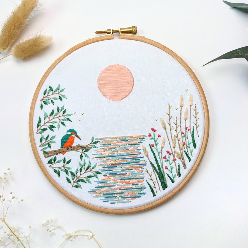 Birdseye view of Kingfisher Lake embroidery kit by Tales from the Hoop. A nature themed craft project for all skill levels. Premium embroidery kit with detailed illustrations high quality sustainable packaging and a mindful and fun craft.