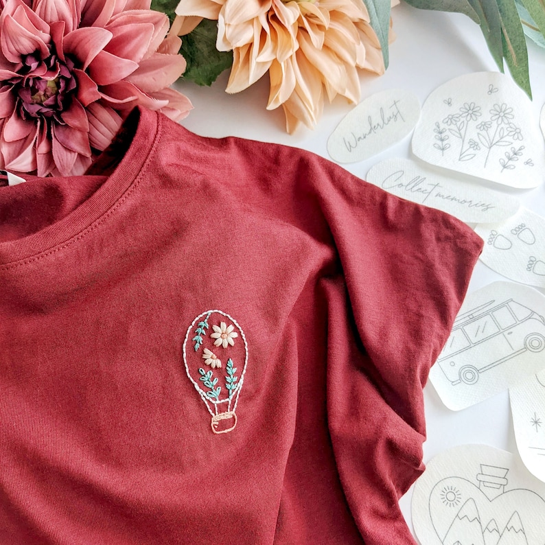 Beautiful stick and stitch embroidery design featuring a hot air balloon on a red tshirt. Escapism and embroidery combined. Easy embroidery for beginners and quick holiday projects. Make your clothes unique and add new life to your clothes.