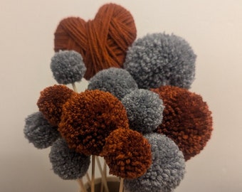 Burnt orange and grey yarn pom-pom bunch