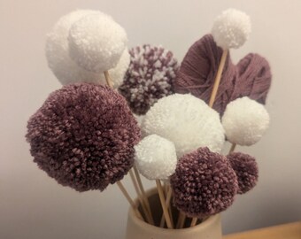 Purple and white yarn pom-pom bunch