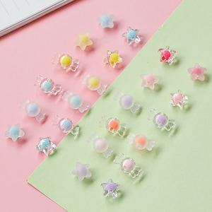 May include: Assortment of colourful candy-shaped and star-shaped resin embellishments. The candy shapes are clear with a coloured centre and the stars are clear with a coloured outline.