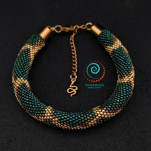 Emerald green snake bracelet with cord ends and lobster claw