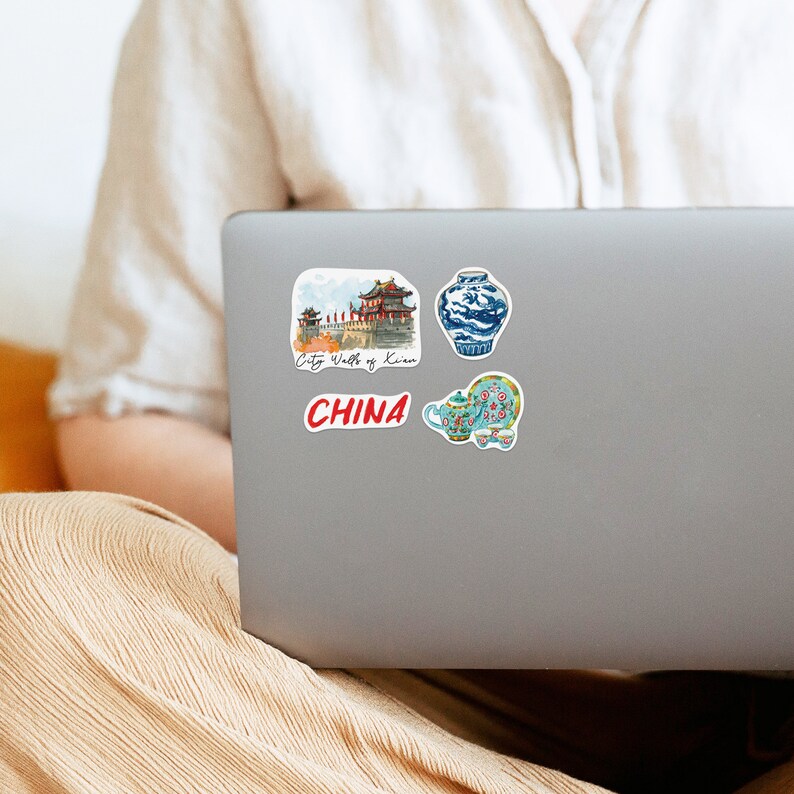 May include: Four stickers featuring Chinese cultural imagery. The stickers include a watercolor illustration of the City Walls of Xi'an, a blue and white porcelain vase, a teapot and two teacups, and the word "CHINA" in red.