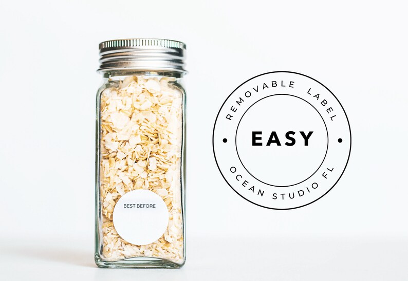 May include: A clear glass jar with a silver lid filled with dried onion flakes. The jar has a white label that says "BEST BEFORE". The jar is sitting on a white surface. A black and white sticker with the text "REMOVABLE LABEL EASY OCEAN STUDIO FL" is in the background.