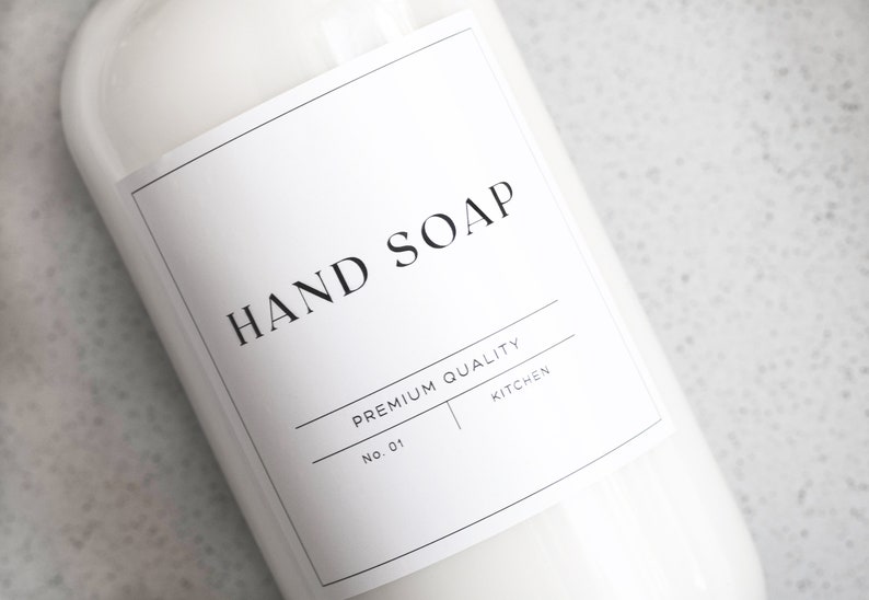 May include: White plastic bottle with a black and white label that reads "HAND SOAP" and "PREMIUM QUALITY NO. 01 KITCHEN".