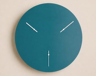 May include: A circular wall clock with a solid teal face and three thin white hands. The clock face lacks numbers or markers, featuring a smooth, matte finish. The three white hands are positioned at different angles, pointing toward the edge.