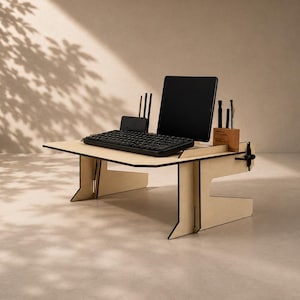 May include: A light-colored wooden desk organizer and laptop stand featuring a flat surface, a vertical slot for a tablet, and integrated compartments for pens and small accessories. The structure is assembled from interlocking panels.