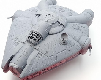 May include: A gray plastic model of a starship featuring a circular main hull, a forward-facing cockpit with a grid-patterned window, a small satellite dish, and intricate surface paneling details including various vents, ports, and side-mounted cannons.